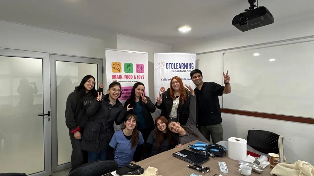 Alumnas y docente junto al pendón de Otolearning al terminar un taller presencial